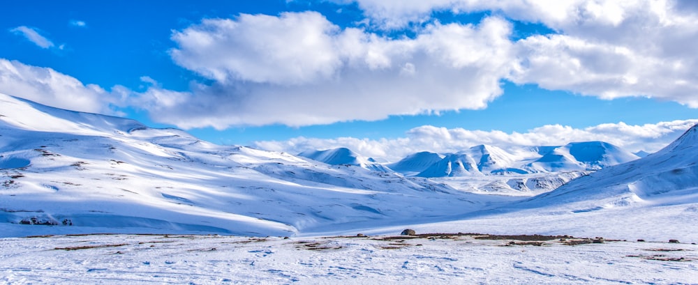 landscape photography of a snow field under a cloudy sky