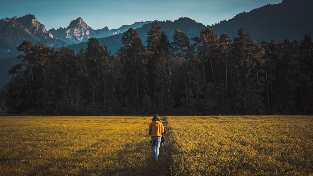 person walking on grass field