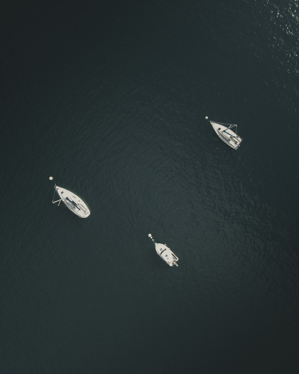 aerial view of three white sailboat
