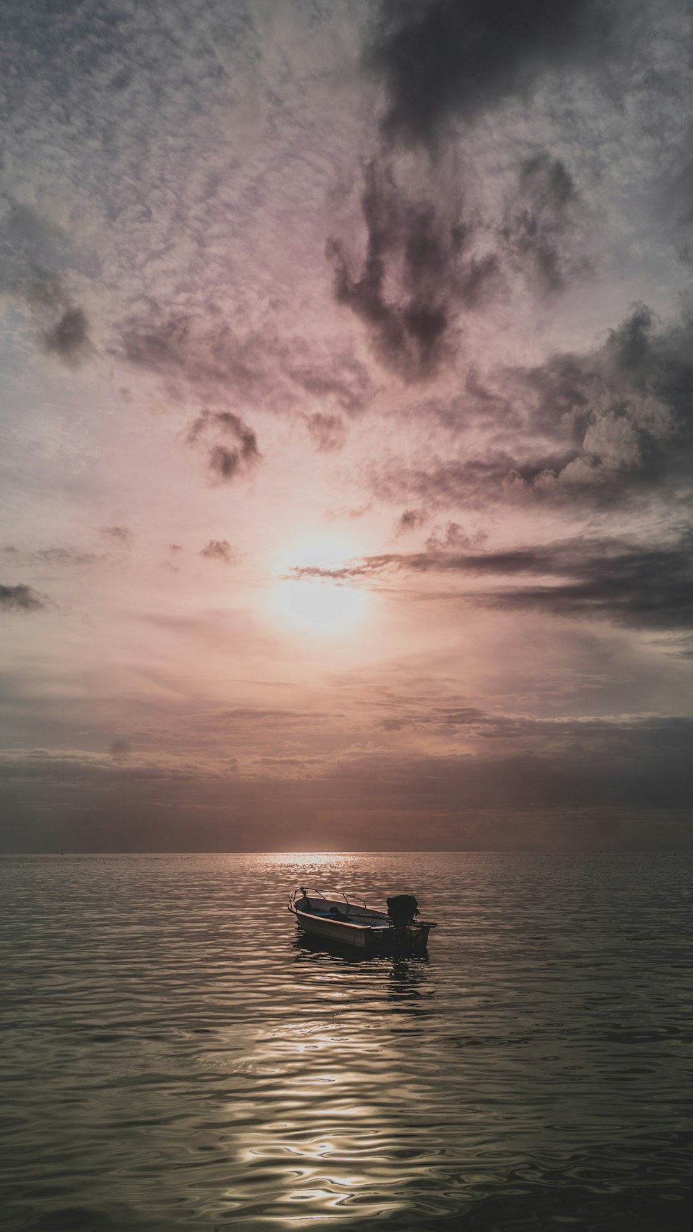 boat on body of water under cloudy sky