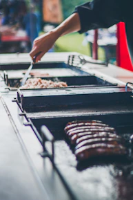 a person is grilling food on a grill