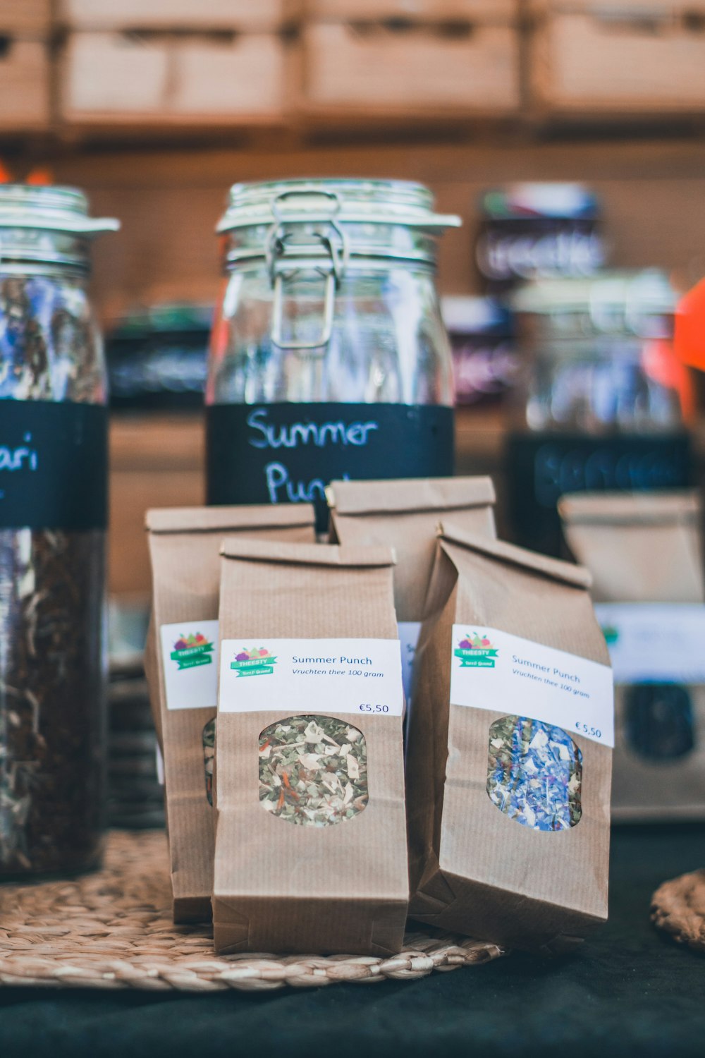 three brown paper bags beside glass jars