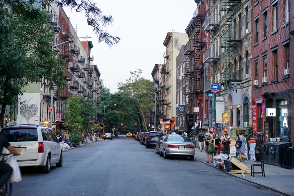 a group of people standing on the side of a street