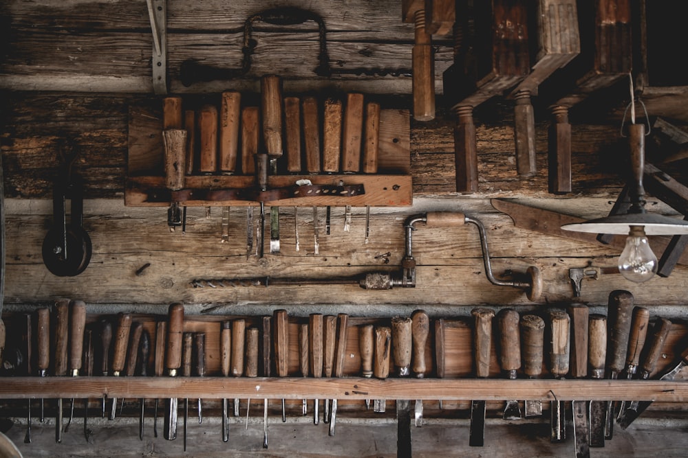 brown wooden chisel set on display near different carpentry tools