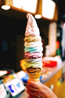 Colorful soft-serve ice cream machine dispensing creamy cones.