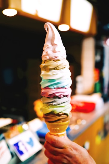 Colorful soft-serve ice cream machine dispensing creamy cones.