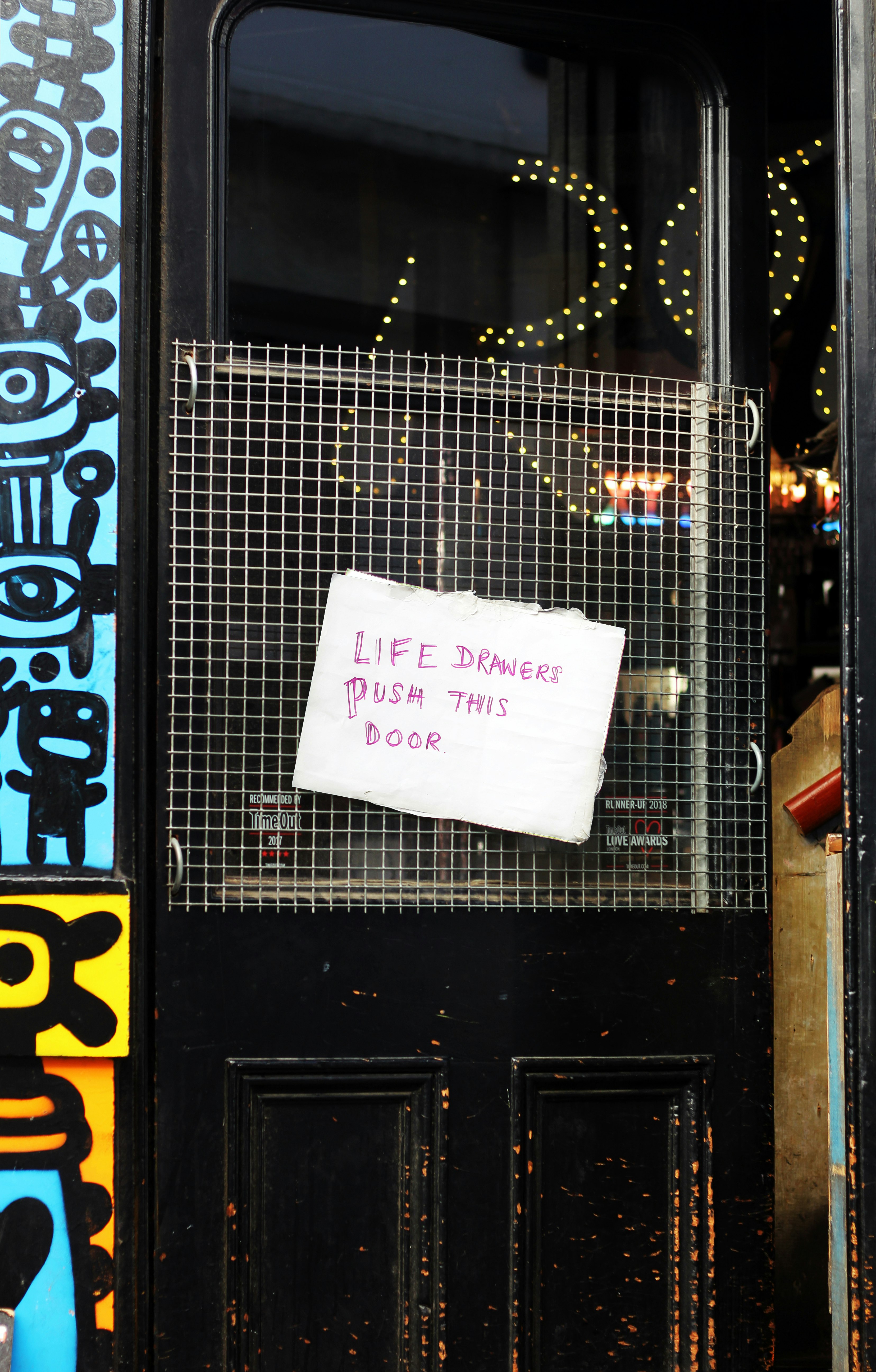 'Life drawers push this door.' The door of a Mexican Bar at Lower Marsh, London.