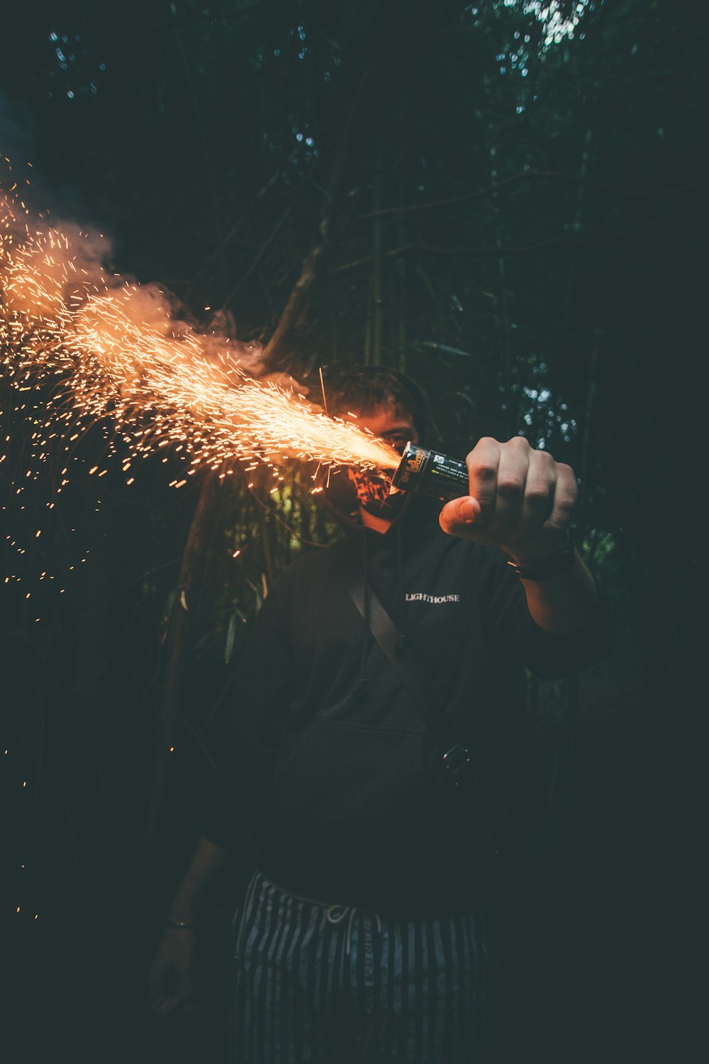 person holding tube with sparks