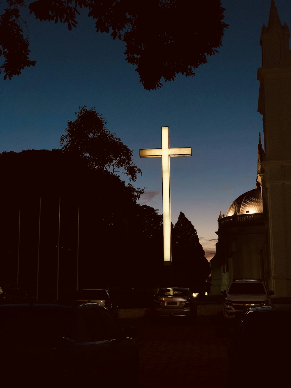 architectural photography of white lighted cross