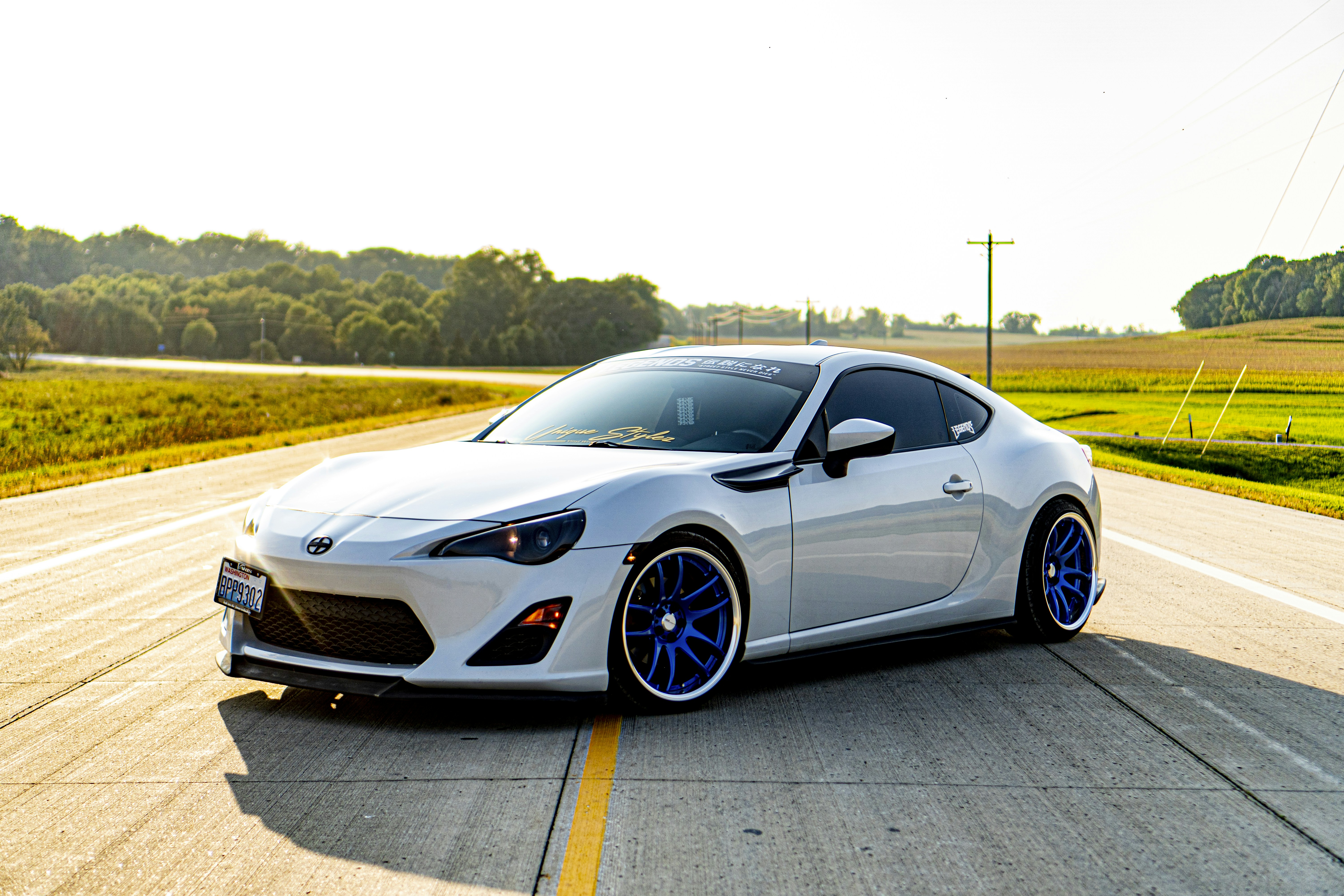 white sports coupe on road