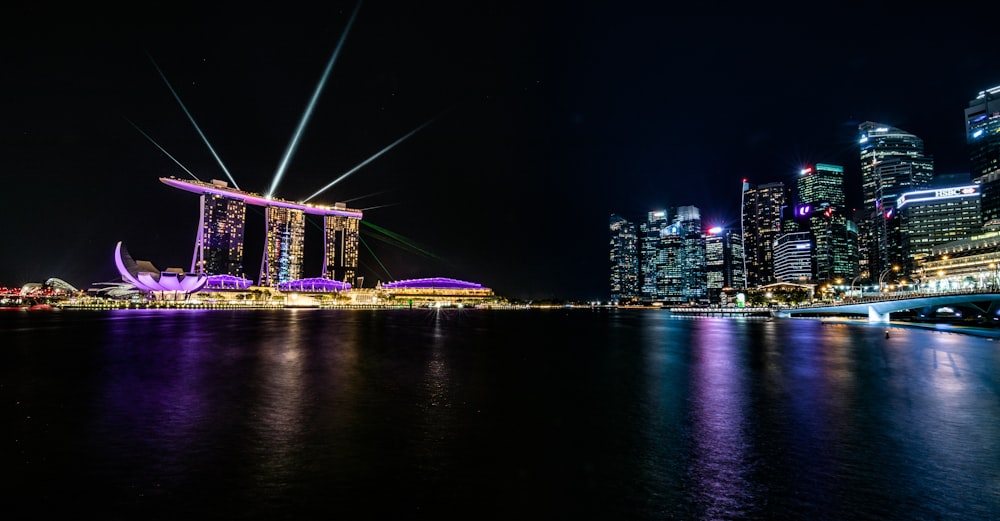 body of water across city buildings during nighttime