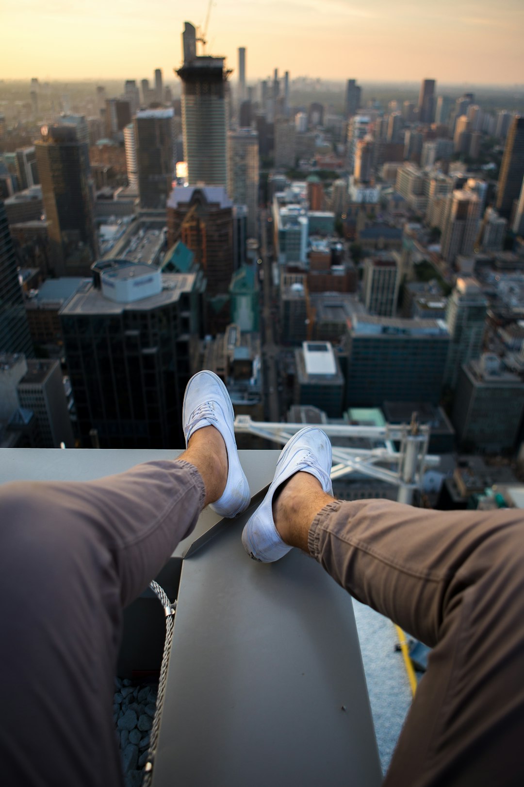 person wearing brown jogger pants and white sneakers