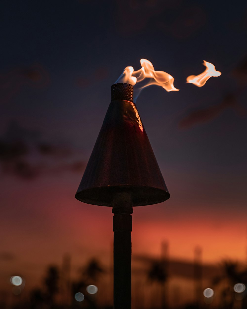 a lamp post with some fire coming out of it