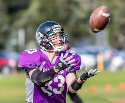 American football player catching a pass