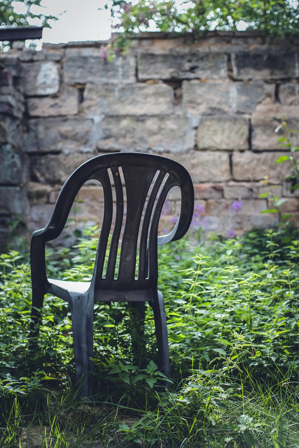 black monoblock chair on grass field