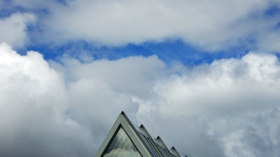 Modern rooftop with sharp edges against a clear blue sky in Klosters