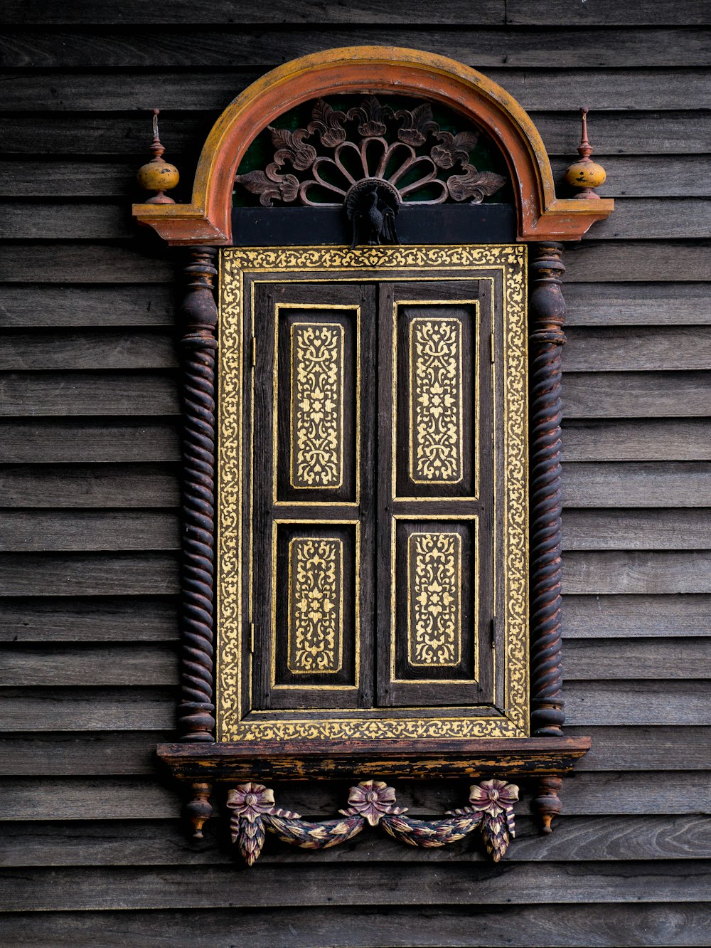 a wooden door with a decorative window frame
