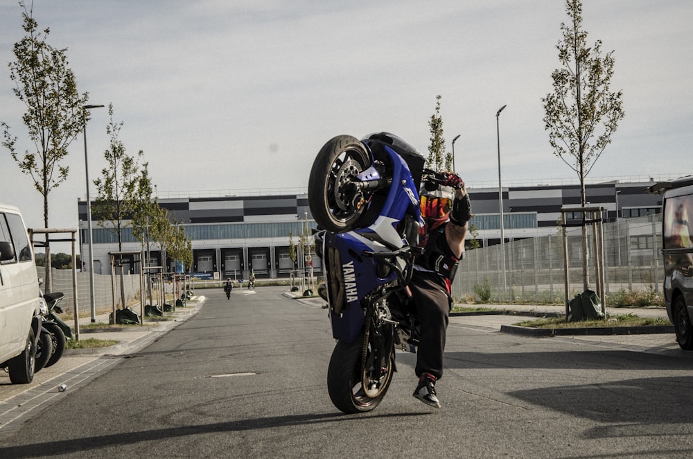 man doing stunt on sports bike