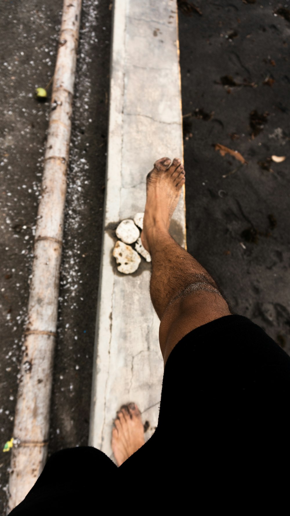 a man standing on a sidewalk next to a street