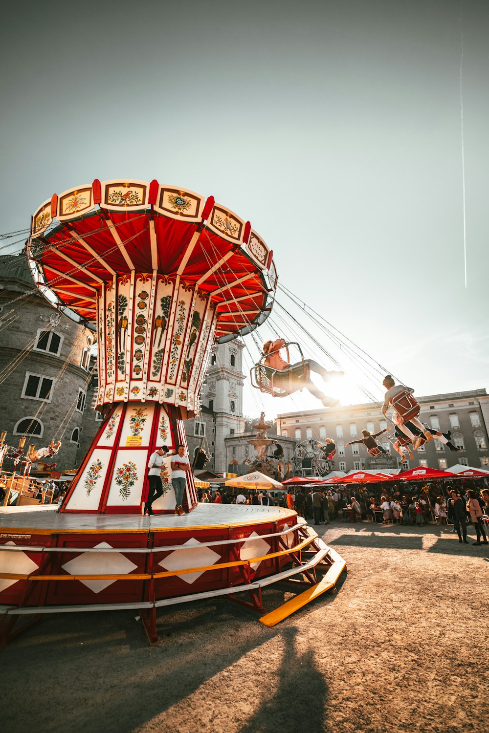 people riding revolving amusement park ride near people during day