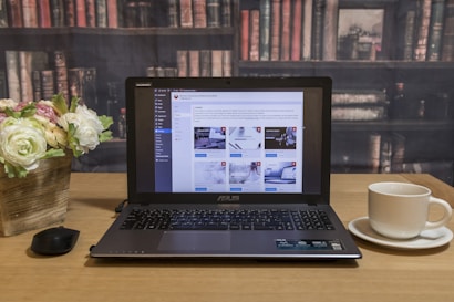 black laptop computer on brown wooden table