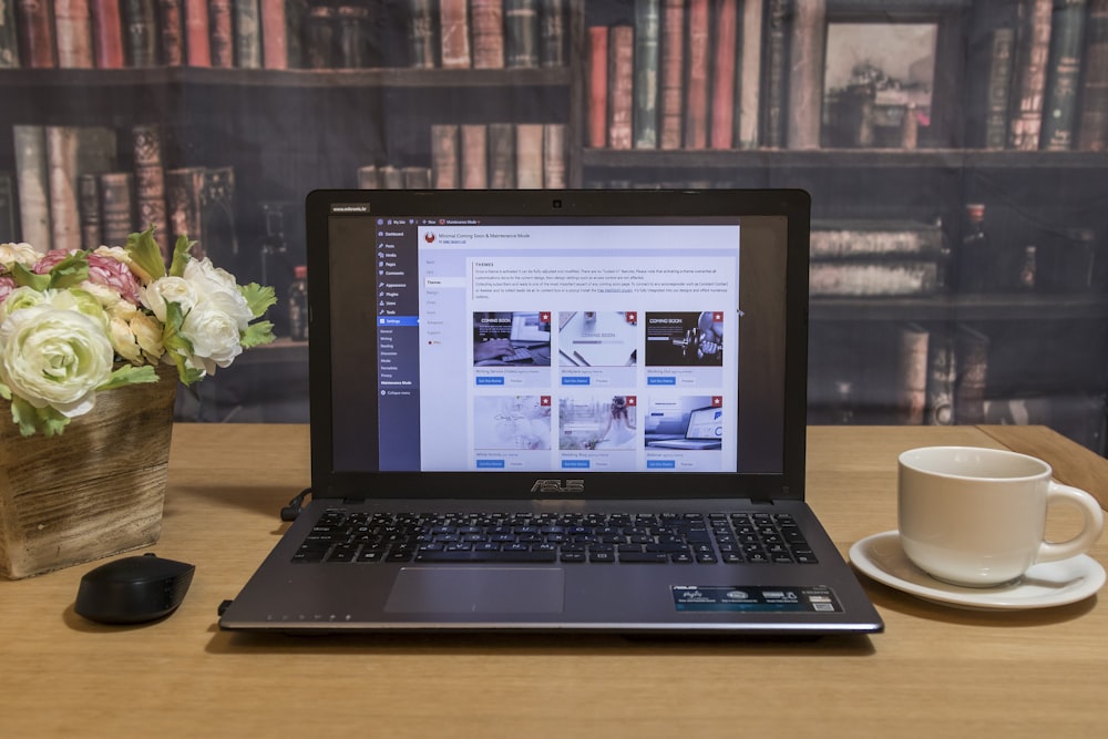 black laptop computer on brown wooden table