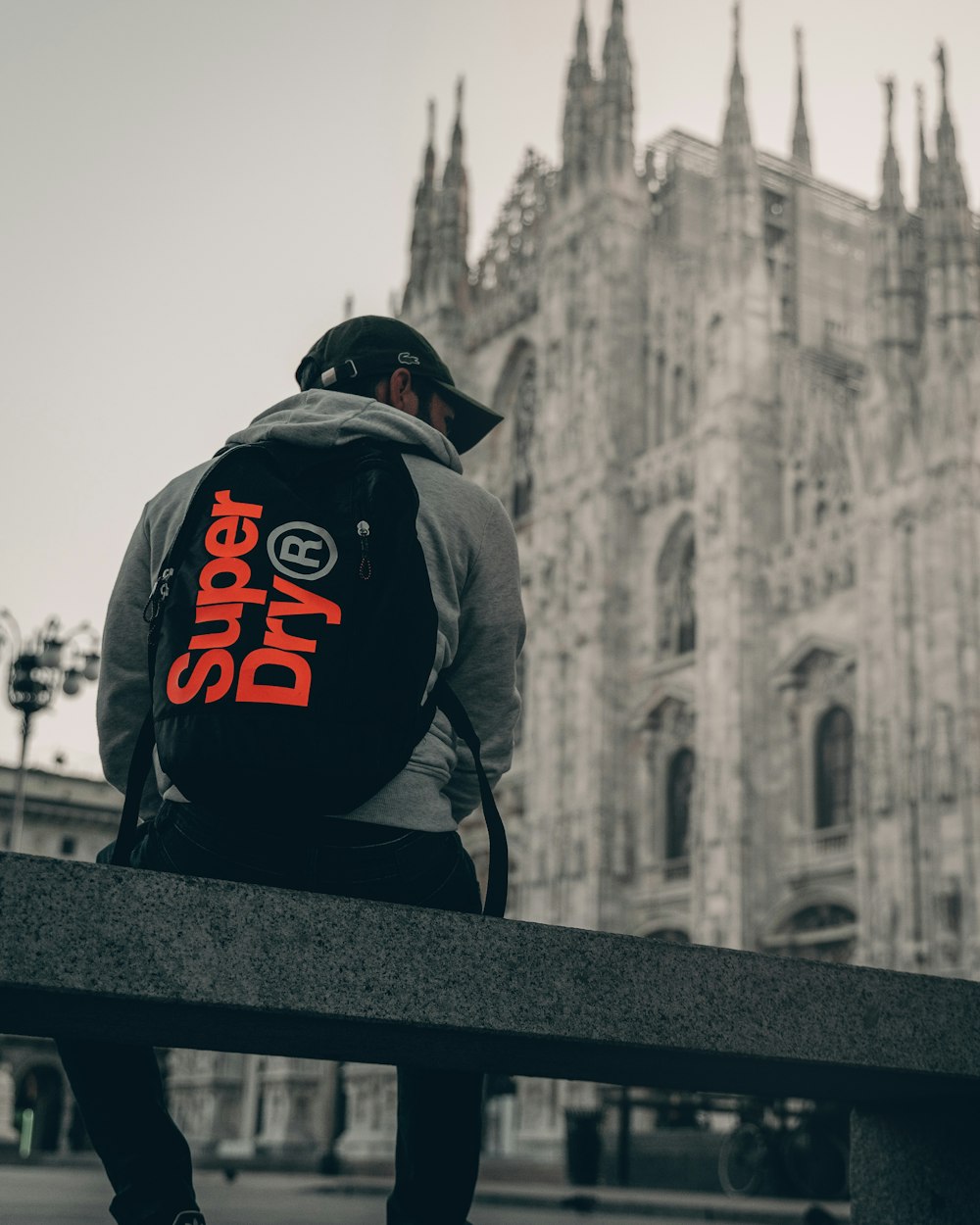 man carrying black Super Dry bag