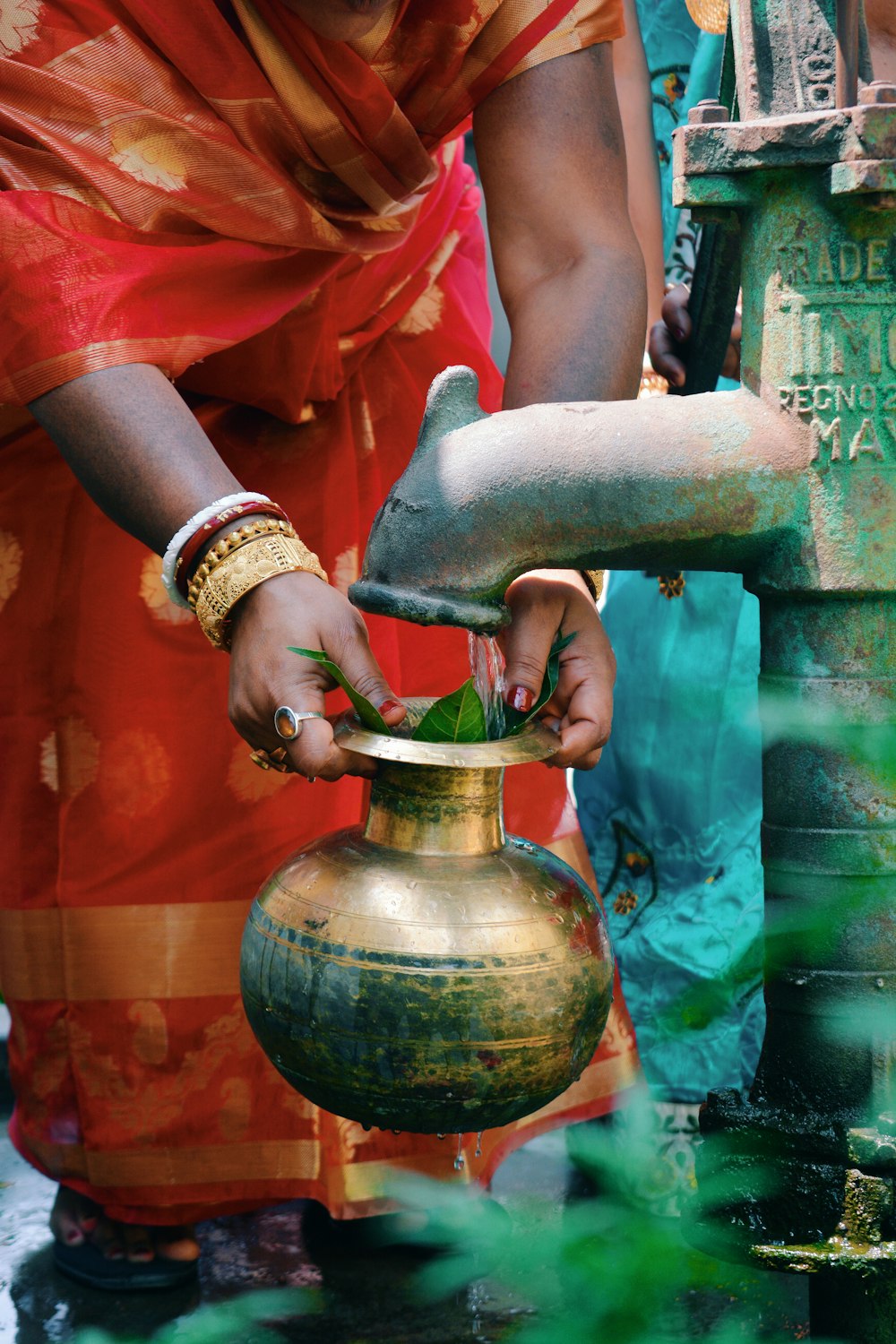 person holding gold pot