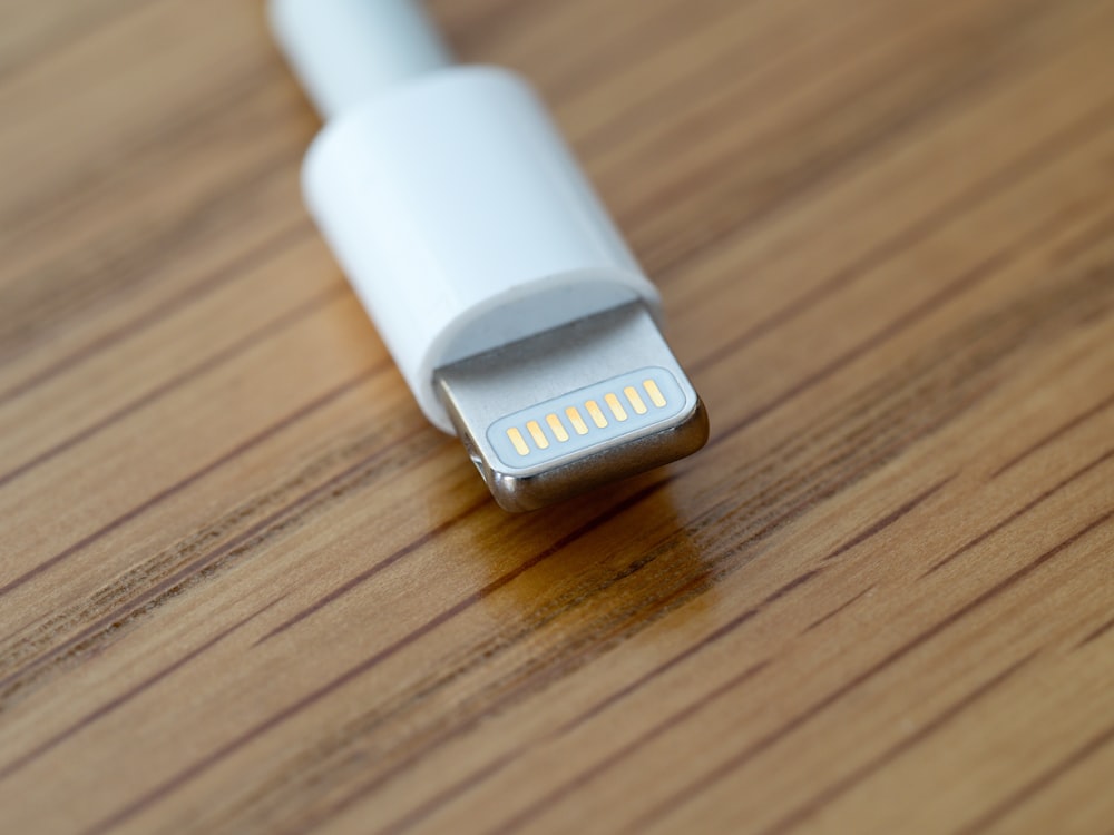 a close up of a usb cable on a wooden surface