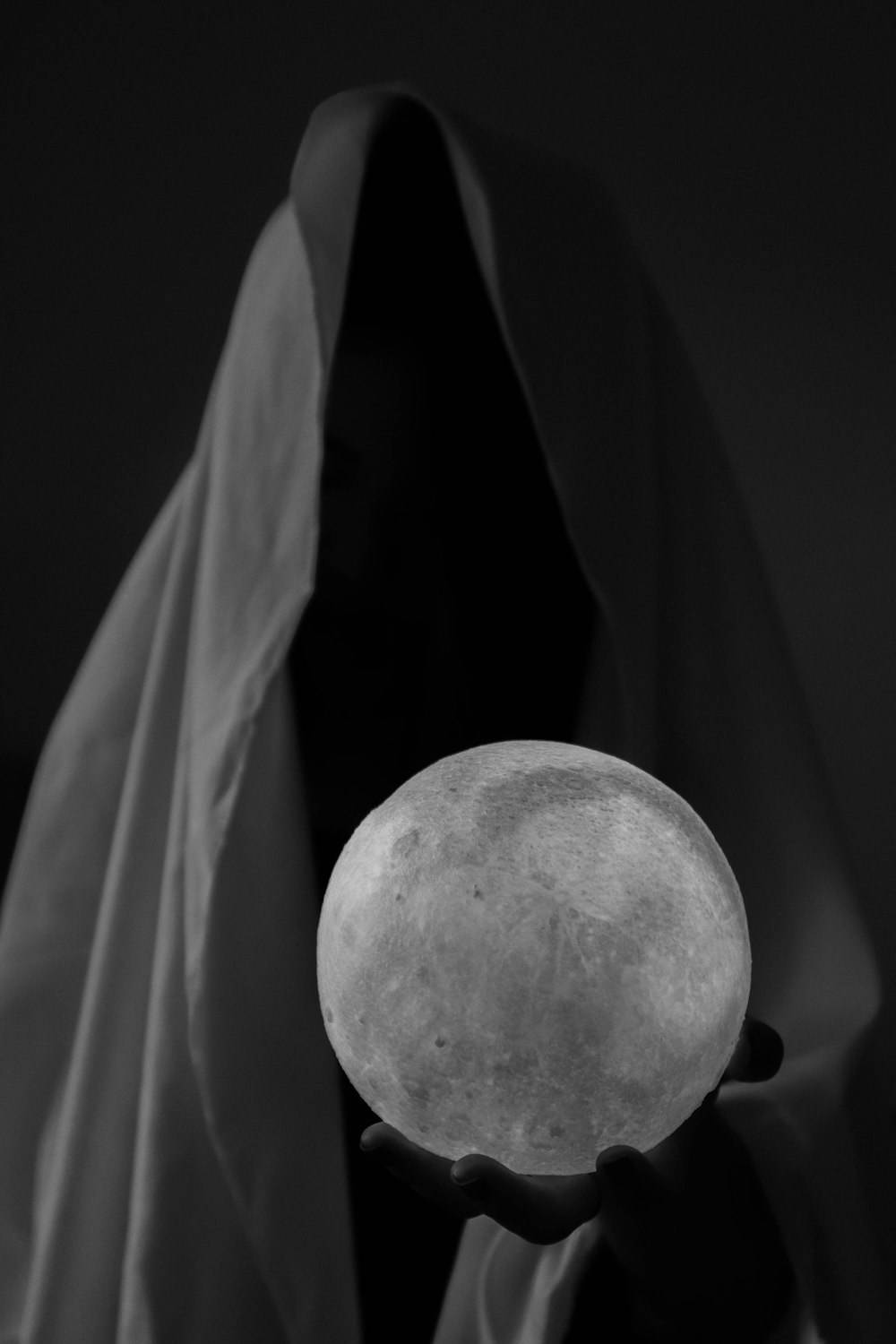 grayscale photo of person holding ball