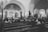 A serene church interior with a small congregation engaged in worship and prayer.