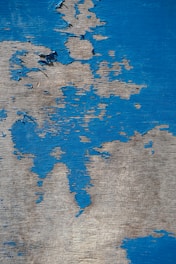 a close up of a piece of wood with blue paint on it