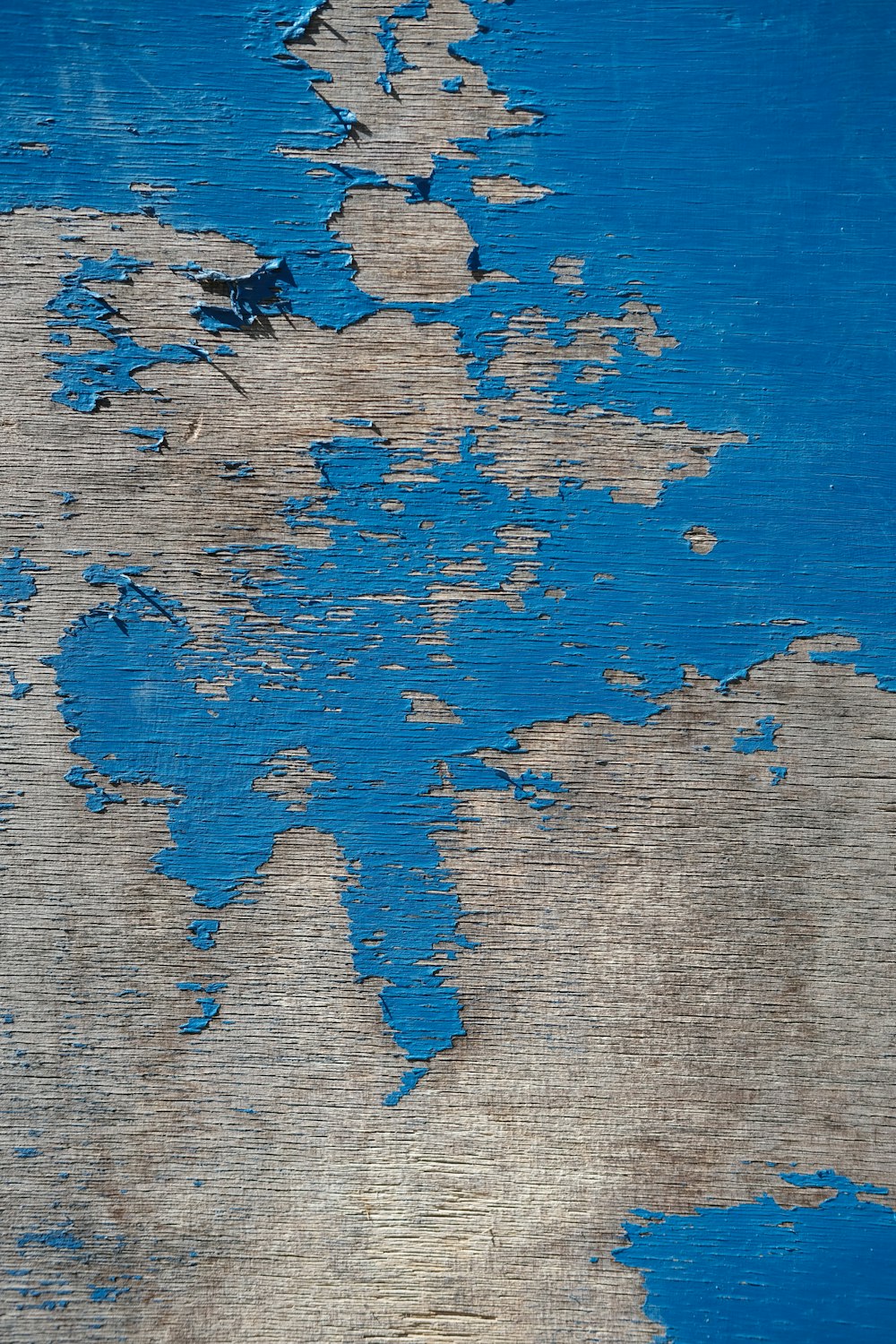 a close up of a piece of wood with blue paint on it
