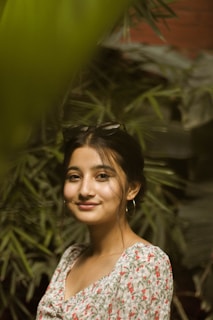 Outdoor portrait of a woman with sun-kissed skin wearing a statement hair accessory, framed by eucalyptus leaves.
