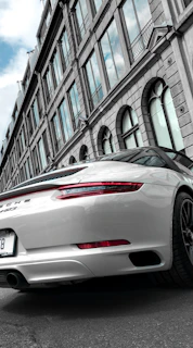 High-angle photo of a shiny sports car parked on a city street after detailing.