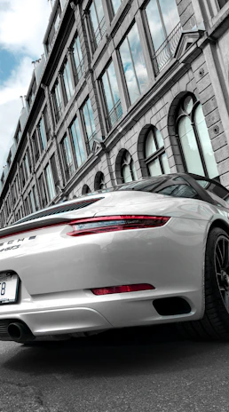 High-angle photo of a shiny sports car parked on a city street after detailing.