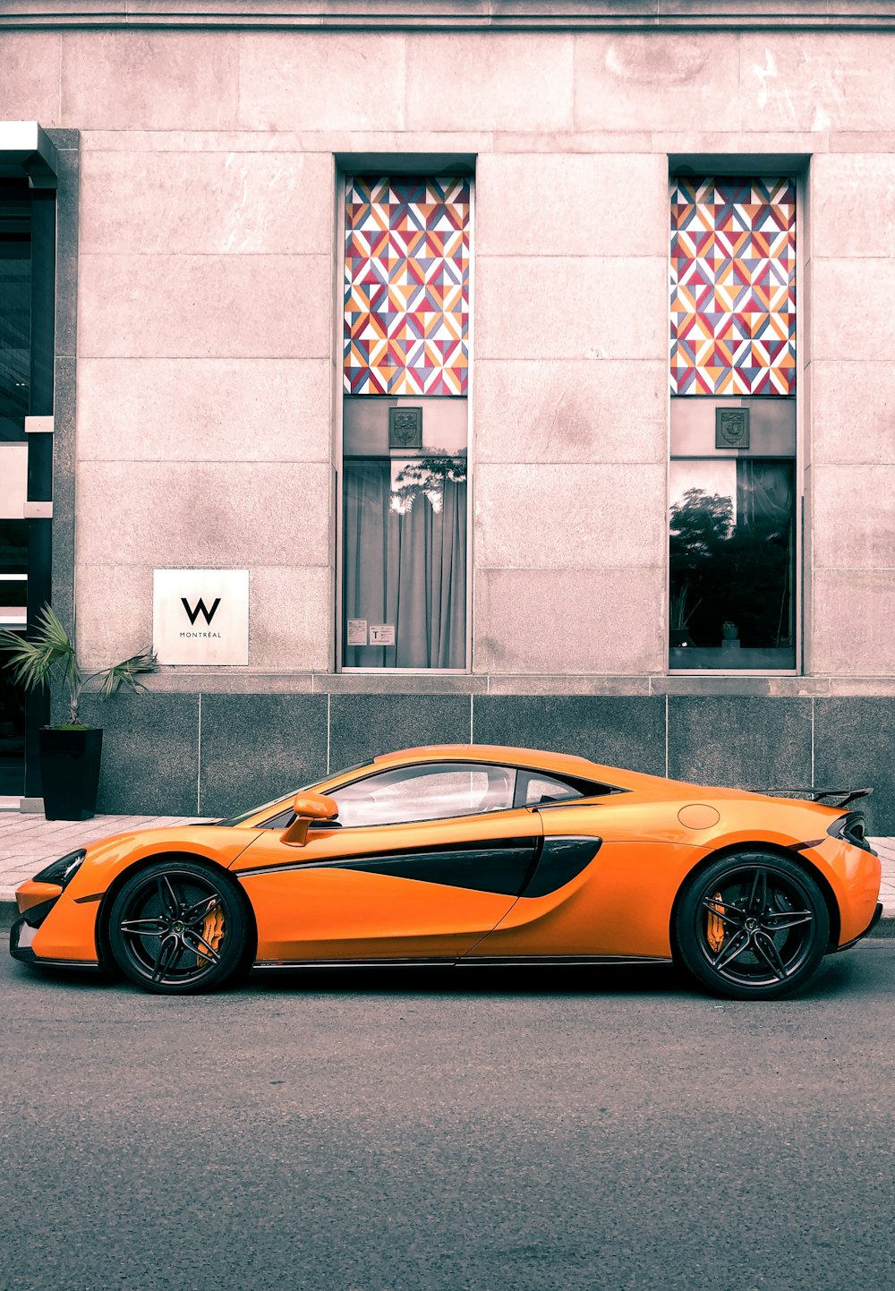 orange Mclaren MPr-12c parked at roadside