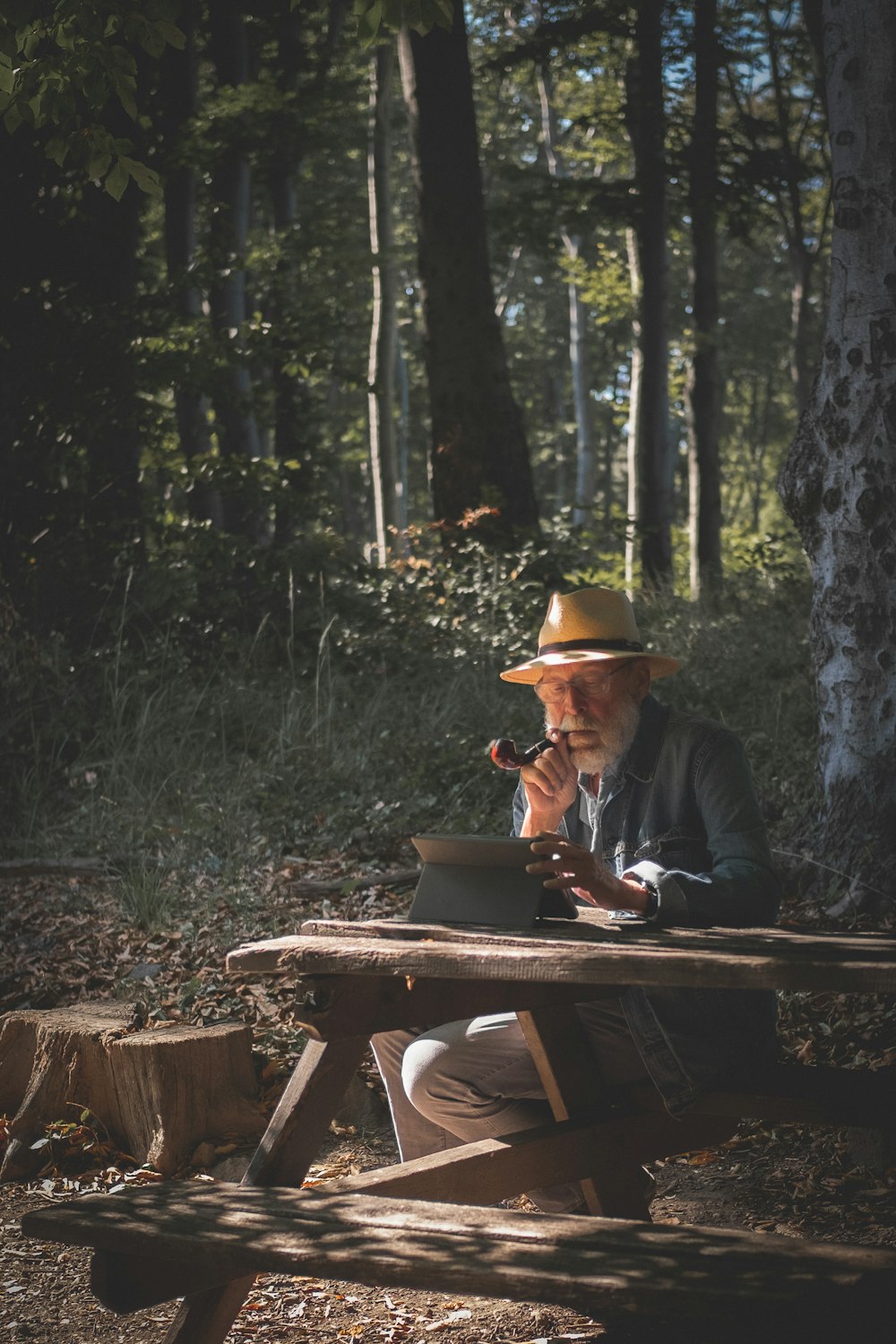 man sitting on picnic table smoking outdoors
