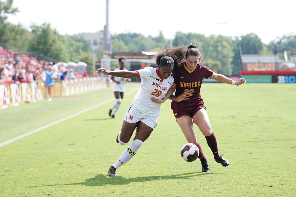 women playing soccer during day