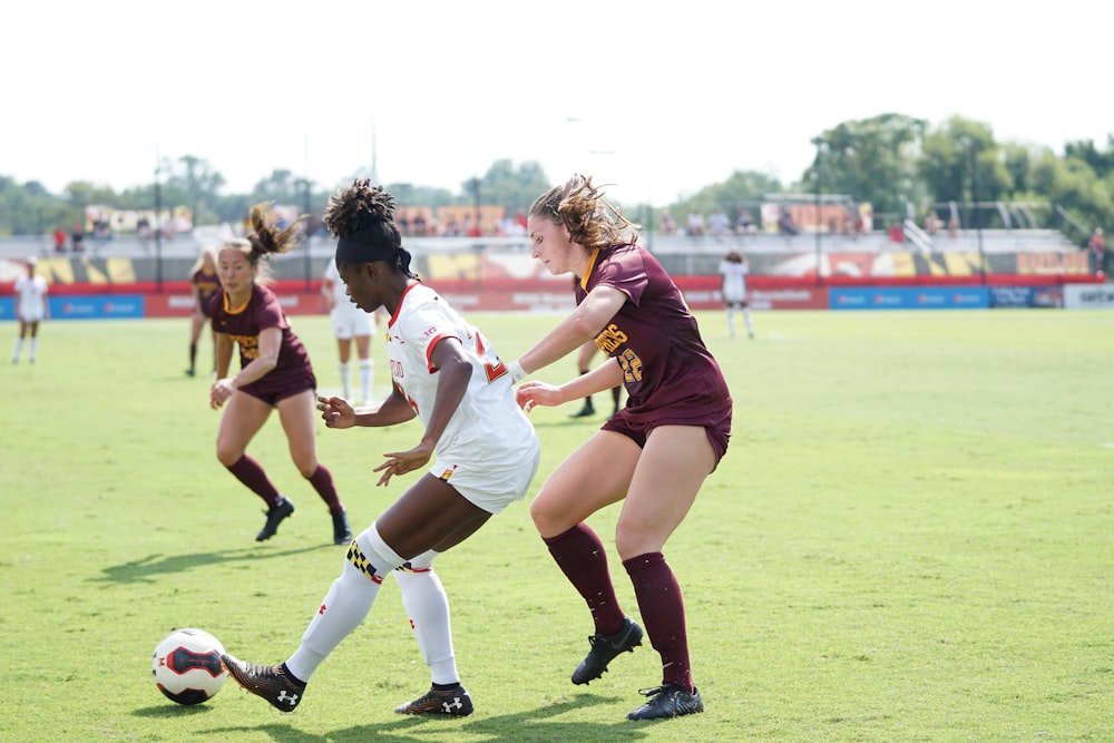 women playing soccer at daytime