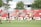 A group of enthusiastic athletes engaging in a friendly soccer match on a sunny day.