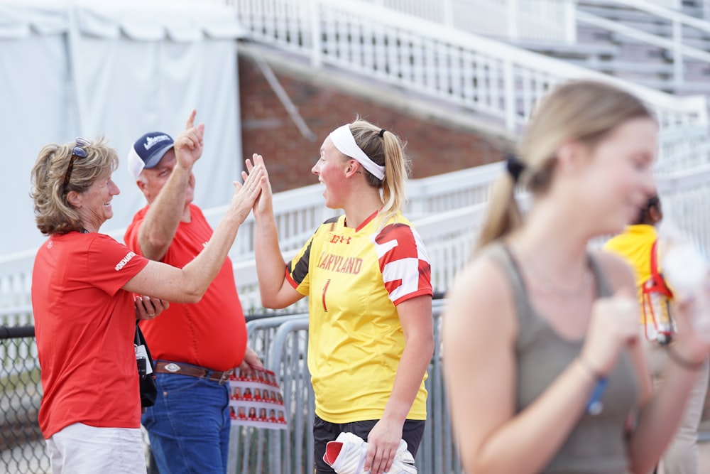 women clapping by man during daytime