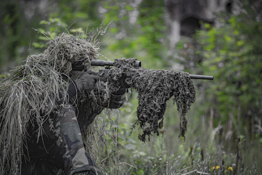 Competitor aiming carefully during the stalking stage, blending with the terrain