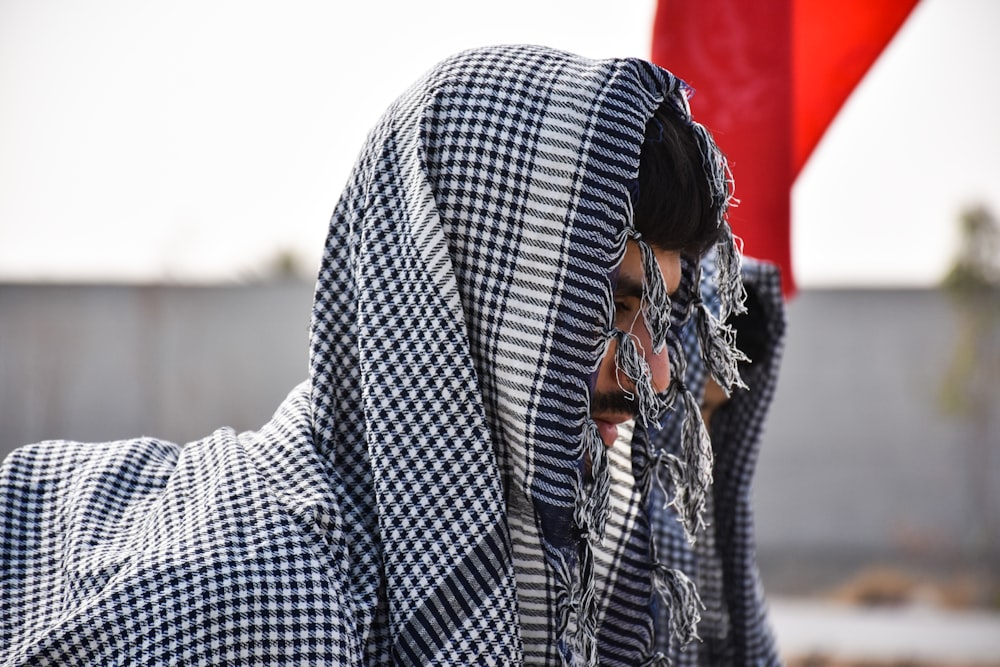 selective focus photography of man wearing gray and black headscarf