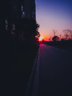 A vibrant sunset casting golden hues over a quiet city street.