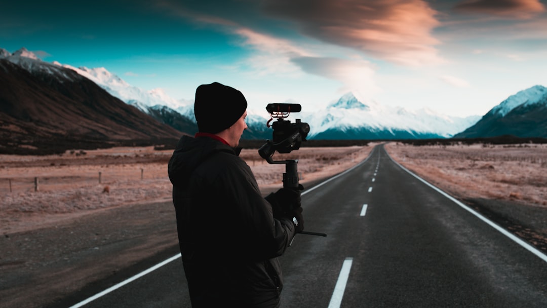 man holding black camera