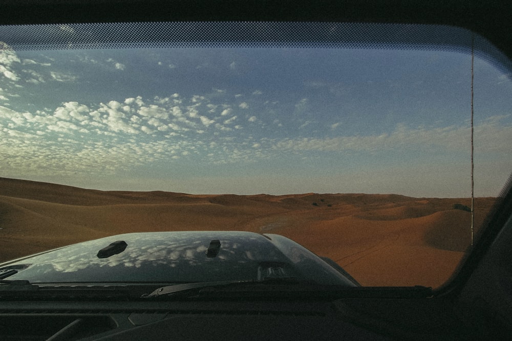 gray vehicle on sand during daytime