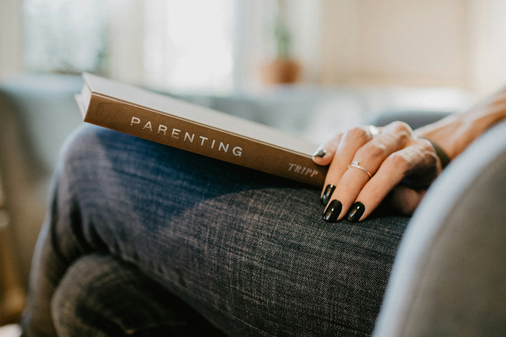 Parenting book on a woman's lap