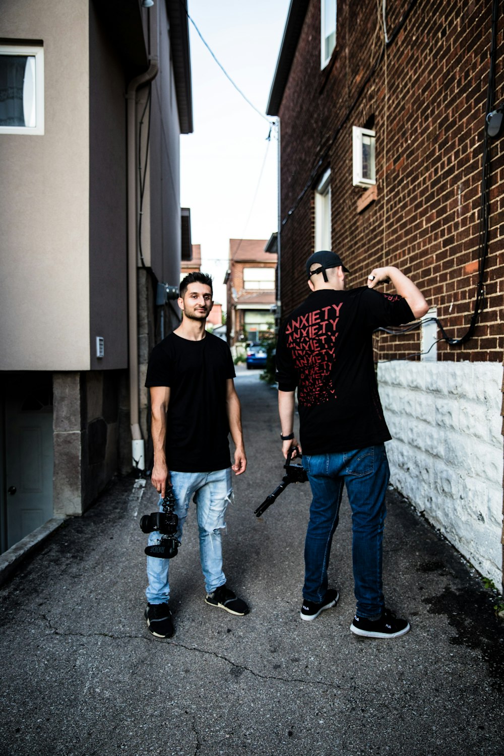 two men standing in the middle of road