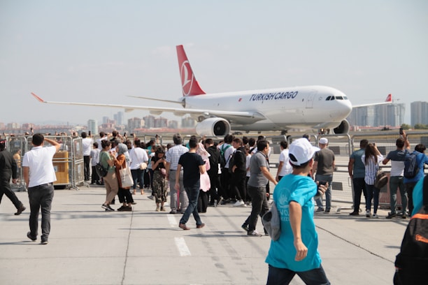 A cargo plane being loaded with aircraft parts at a bustling airport in Turkey.